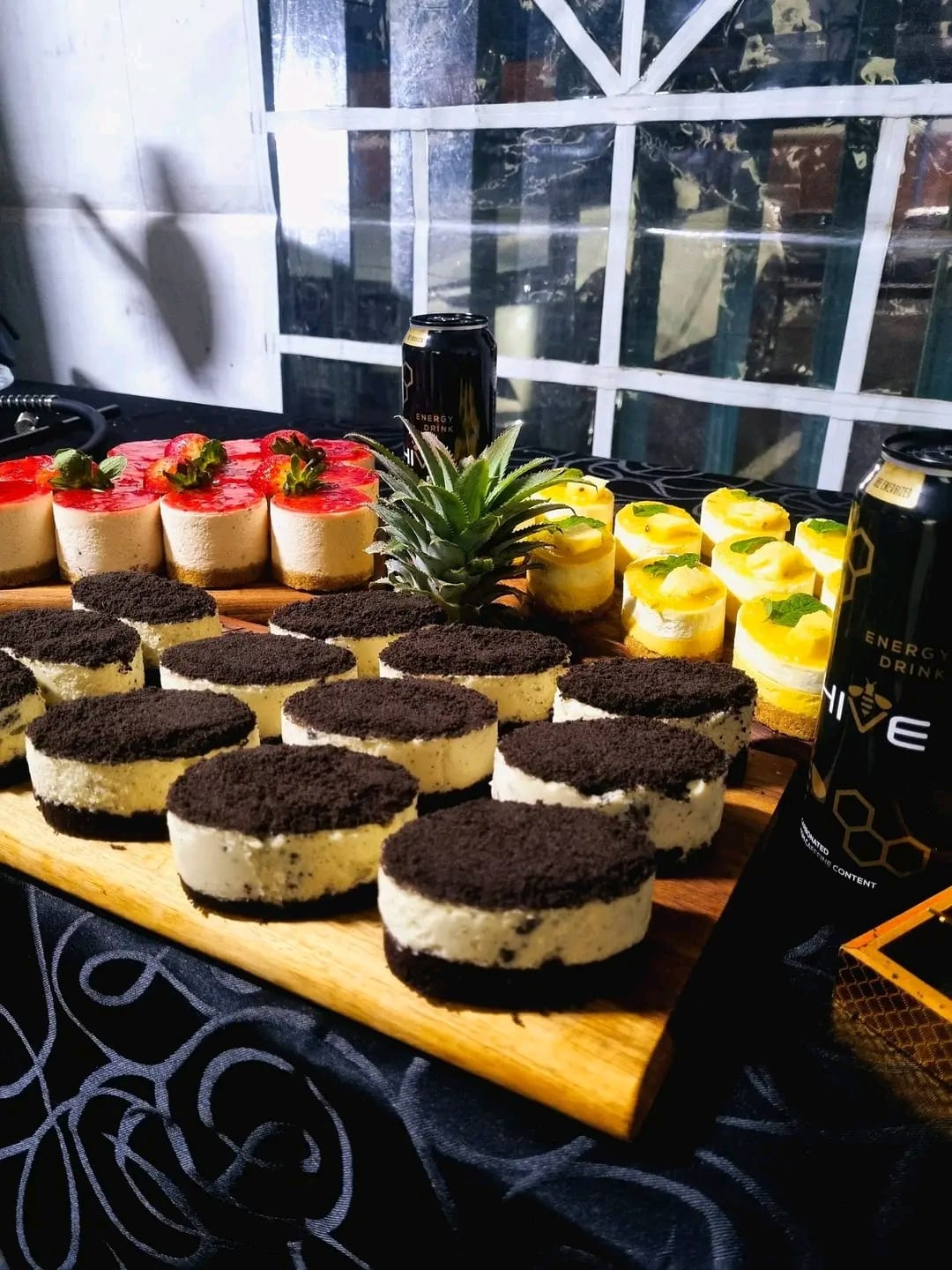 Oreo cheesecakes, strawberry cheesecakes and mango dessert cups on board