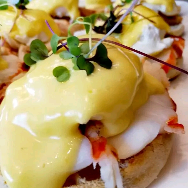 Lobster Eggs Benedict with cascading golden Hollandaise