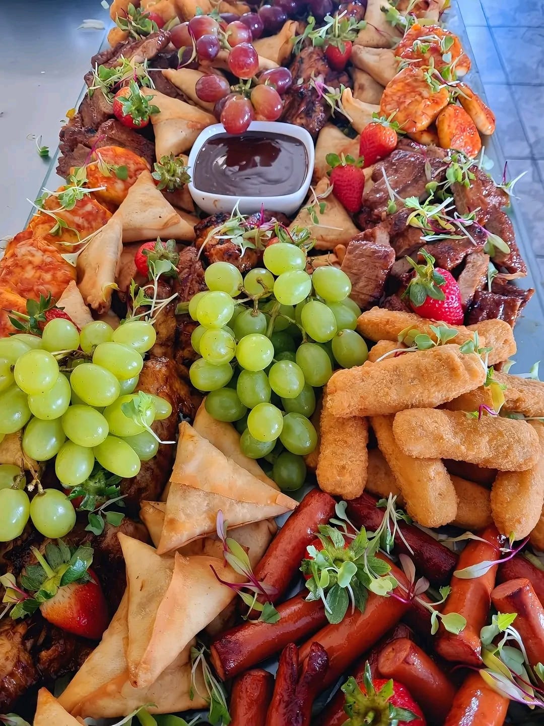 Mega signature grazing board with grapes, samosas, meatballs and nuggets