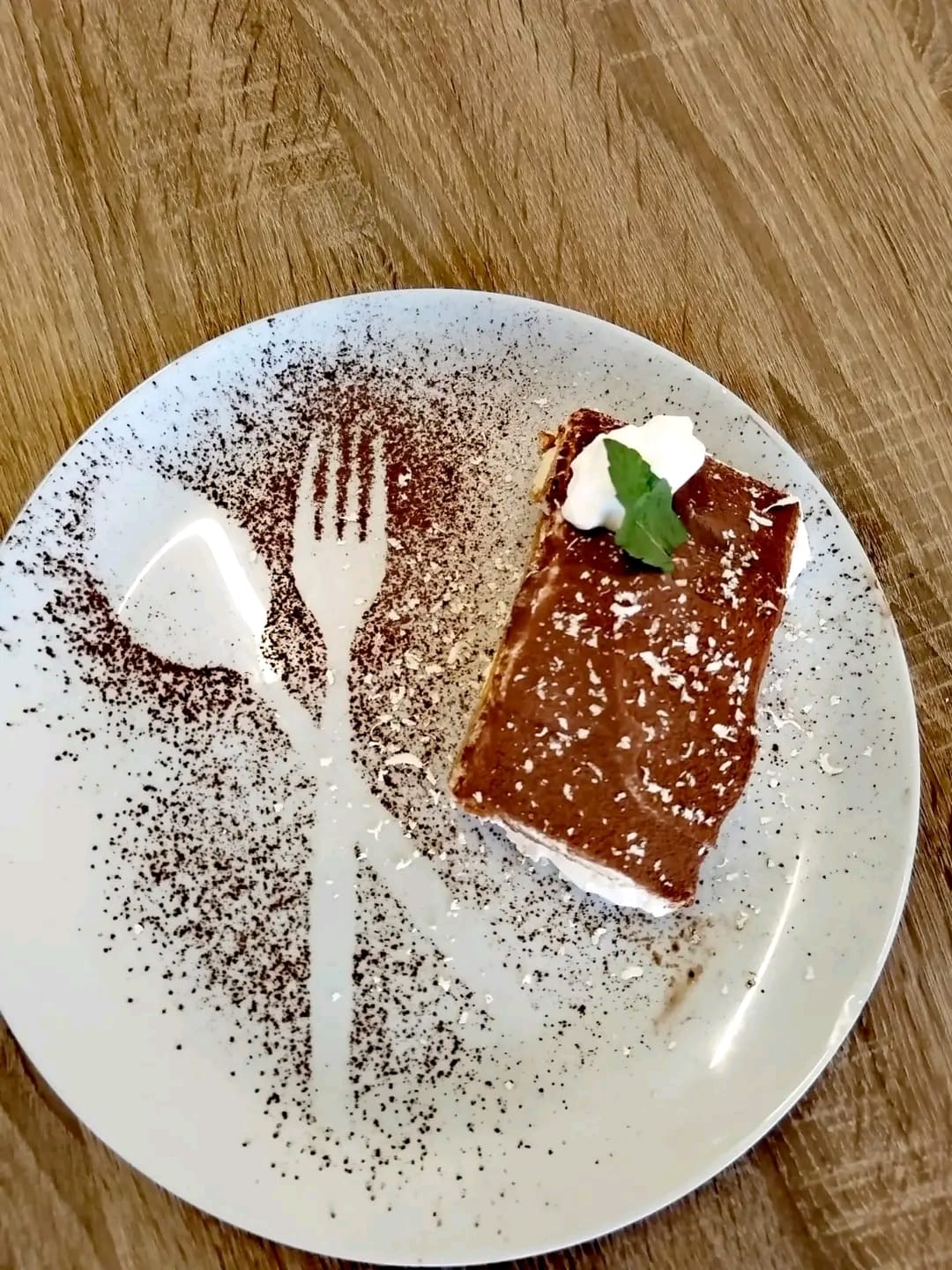 Artisan Tiramisu with cocoa-dusted fork and spoon shadow art